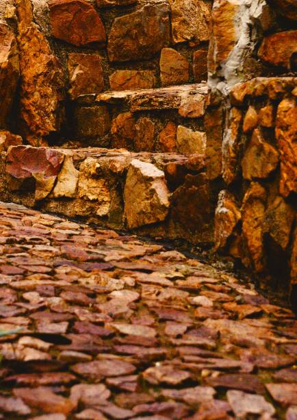 Rock stairs on stone path with greenery in the background