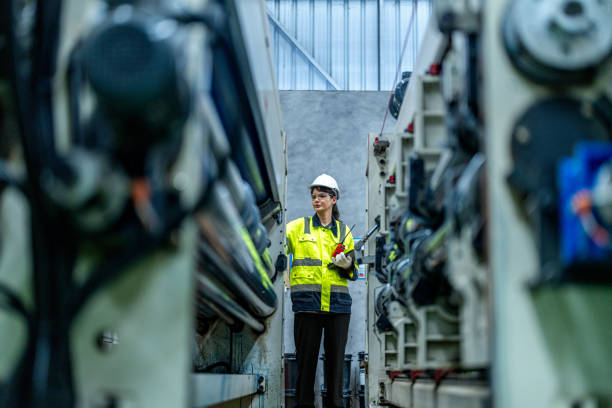 istock female engineers in neat work clothes prepare and control the production system of large modern machines in a factory producing industrial technology products. 2155879005