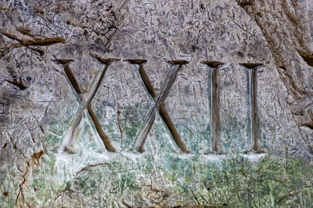 istock Roman numerals carved on ancient building wall 2155879070