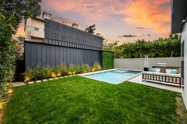 istock Backyard featuring a pool and fenced area with lush green grass. 2155879205