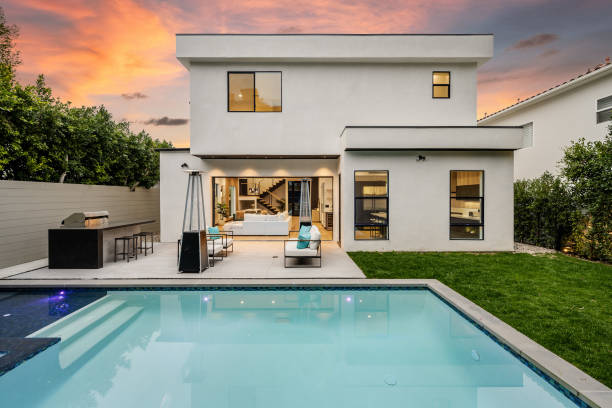 istock a modern home with a large pool near it at sunset 2155879210