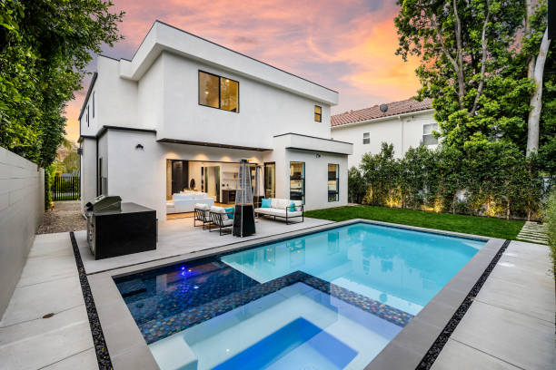 istock a pool and lounge area at sunset in a backyard with a patio 2155879300