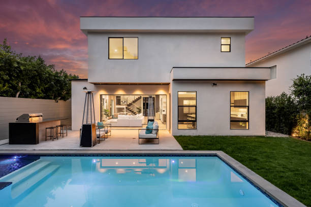 istock a white house with a pool and chairs at night under a pink sky 2155879308