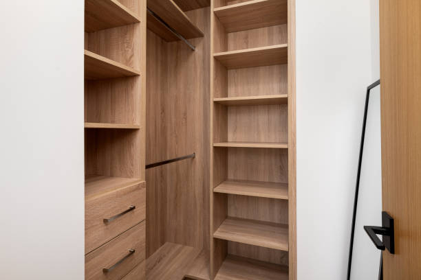 istock an empty wooden closet with a walk in closet space and a book shelf 2155879359