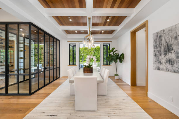 Contemporary home with wood ceiling, white sofa, and glass walls