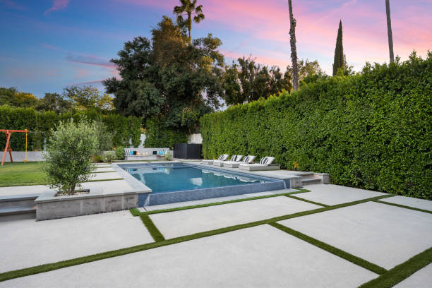 istock a small swimming pool sits between some hedges with green grass in front 2155879531