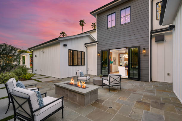 istock Outdoor seating area with a fire pit and chairs during sunset. 2155879535