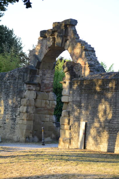 istock Old brick arch over vintage park gate in sunlight 2155879944