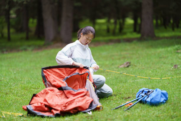 Asian junior high school students build tent in the forest