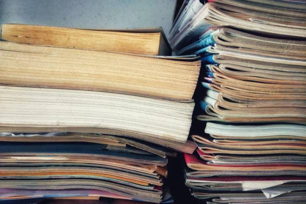 istock Stack of newspapers near a shelf 2155882542