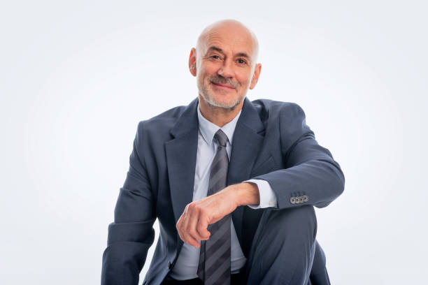 istock Mid aged man wearing suit and sitting against isolated background 2155883516