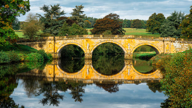 istock Bridge reflections with lots of trees creating a natural nature look. 2155884095