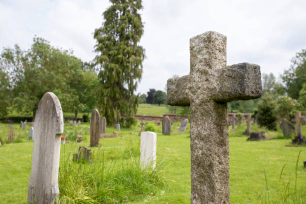 istock Cross-shaped gravestone in a church grounds 2155884337