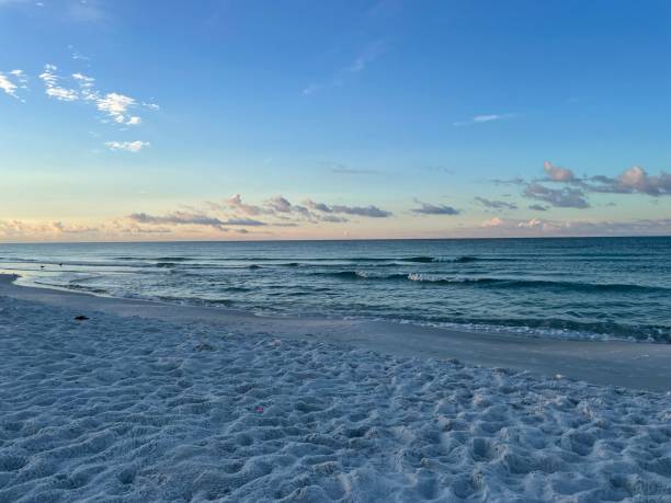 istock Sandy beach with serene ocean waves at dusk 2155884865