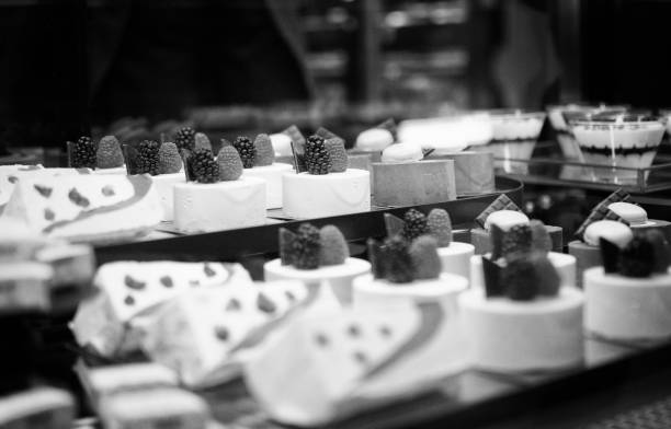 A close-up of various sweets and pastries displayed on shelves in a bakery