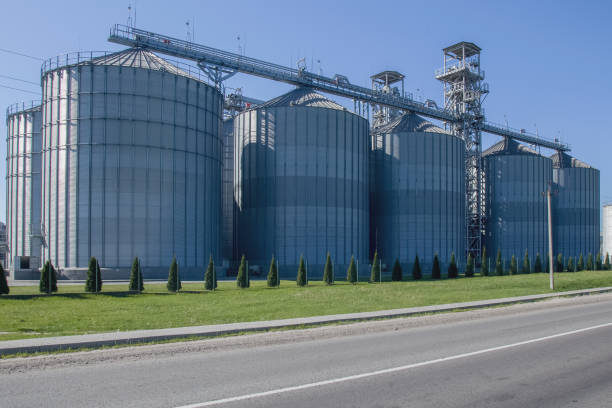 Granary. A large modern agro-processing plant for the storage and processing of grain crops. Large metal barrels of grain. Granary elevator. Horizontal image.