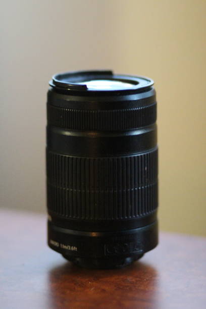 istock a camera lens is set up on a wooden table near a window 2155886385