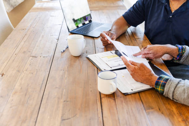 istock Unrecognizable senior man discusses paperwork with unrecognizable adult son 2155887053