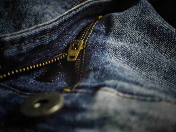 istock Close-up of a denim zipper with a zipper pull, unzipped. 2155887108
