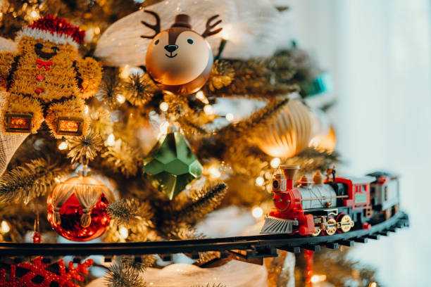 istock Christmas decorations hanging from a Christmas tree as a train passes by. 2155887584