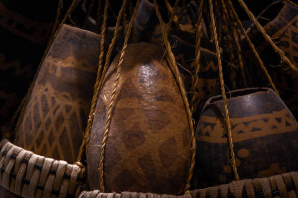 vases and african baskets are hanging on a wall at night