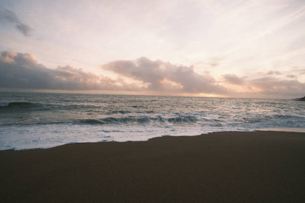 istock Scenic ocean waves crashing at sunset 2155889139