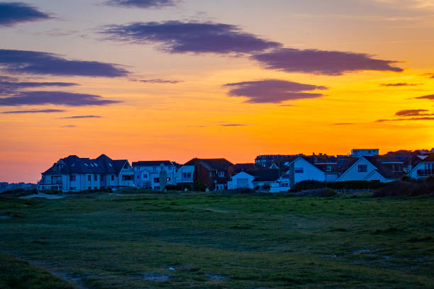 istock Scenic sunset over houses by the roadside 2155889398