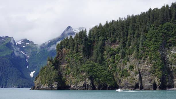 istock Boat surrounded by water with scenic mountain backdrop 2155892676
