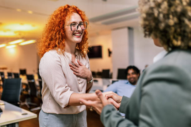 African American woman from Human Resource congratulates the new employee stock photo