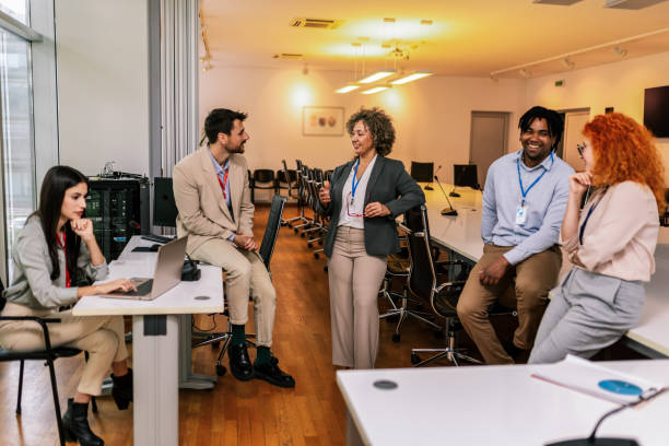 istock Business team standing in a modern office and having a discussion. Group of multiethnic business people working together in the office 2155895155