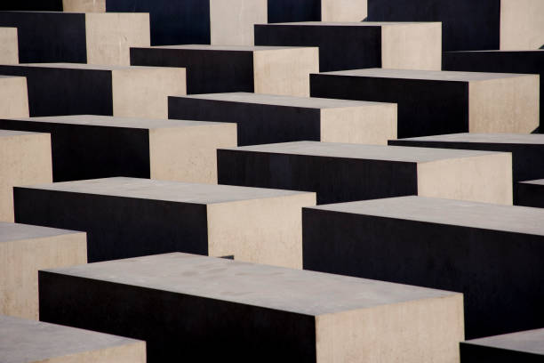 Multiple rows of concrete blocks with a distant building in the background