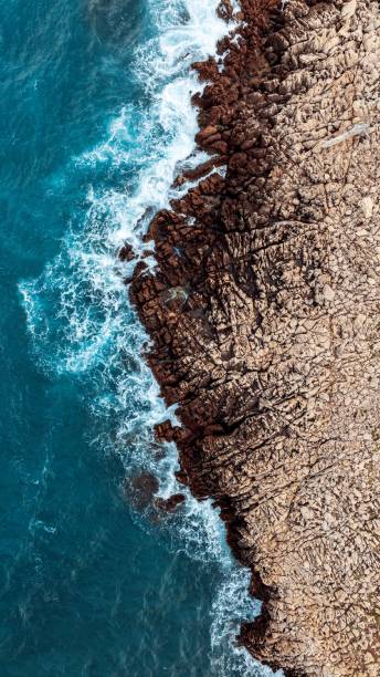 istock a rocky beach next to the ocean on a sunny day 2155897233