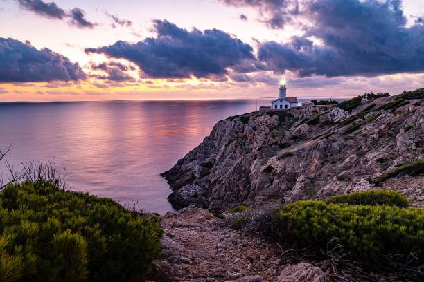 istock a lighthouse on top of a cliff next to the ocean 2155897904
