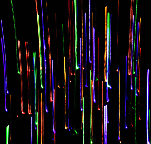 Colored lights with panning against a black background with a fire hydrant
