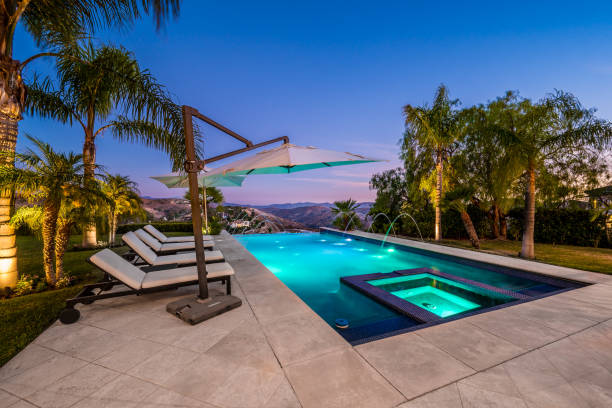 istock a beautiful swimming area with white lounge chairs next to the pool 2155900743