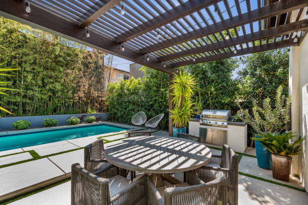 istock patio with table and chairs on it near a swimming pool 2155900859