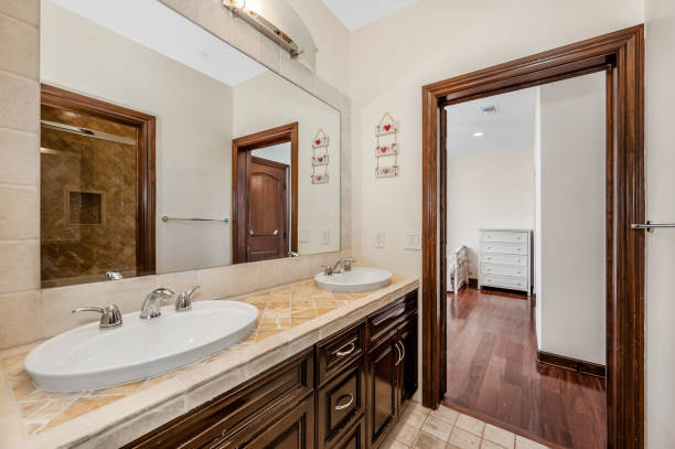 istock a double sink sitting under a mirror next to a door 2155900949