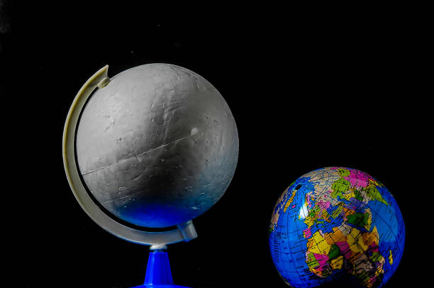 Stone satellite with craters. Planetary Moon in the solar system. Planetoid on a black background.