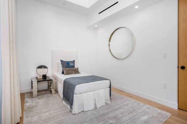 istock a large bed sits in front of a mirror and doorway 2155901080