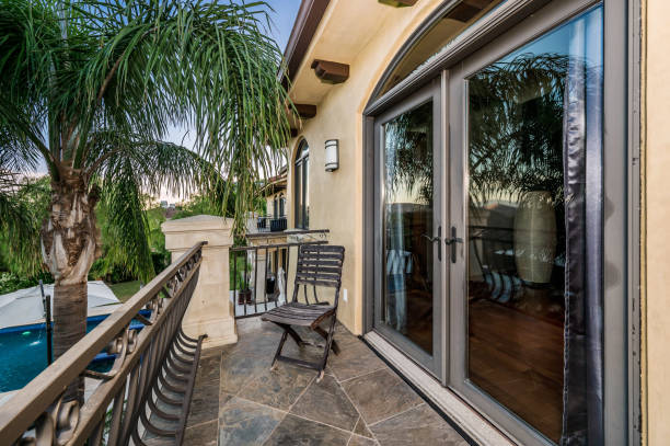 istock an outside patio with glass doors and a table with a potted plant 2155901102