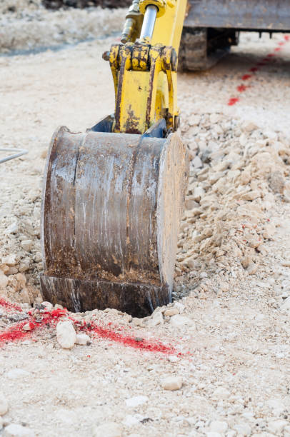 istock Process of excavating for wastewater system at a construction site 2155901471