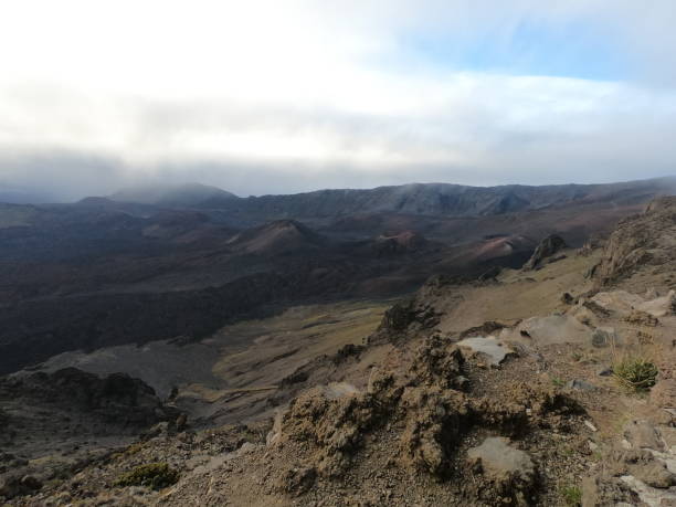 istock Scenic view of rocky hills under cloudy sky 2155901784