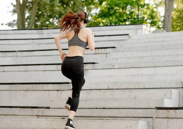 istock Young Girl Exercises By Running Up Stairs 2155901841