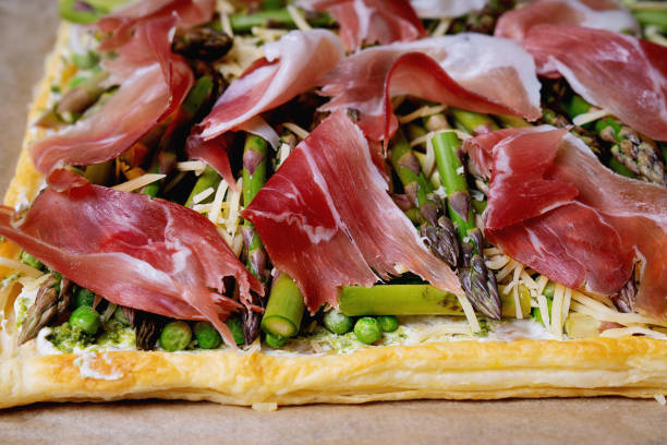 istock Puff pastry tart with asparagus, peas, goat cheese and prosciutto 2155902582
