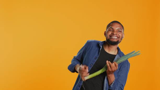 istock Happy person having fun playing guitar at a leek in studio 2155902849