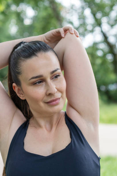 istock Young   woman doing physical exercises outdoors 2155902880