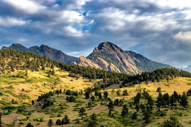 istock Scenic mountainscape view with lush trees against a cloudy sky 2155902901