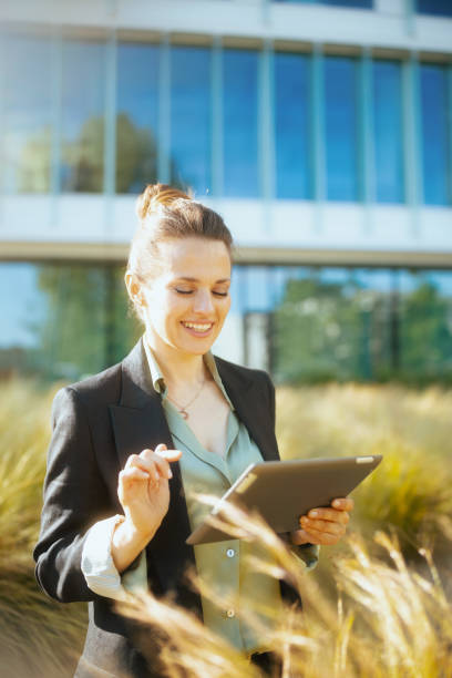 istock happy business woman in business district using tablet PC 2155903838