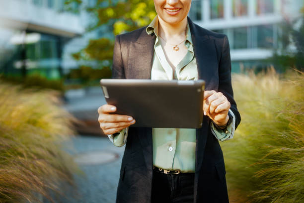 istock Modern business woman in business district using digital tablet 2155903869