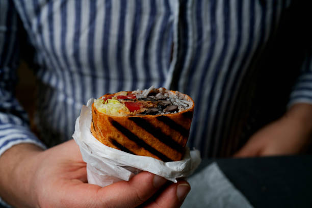 istock Burrito in the hand of a man 2155903881